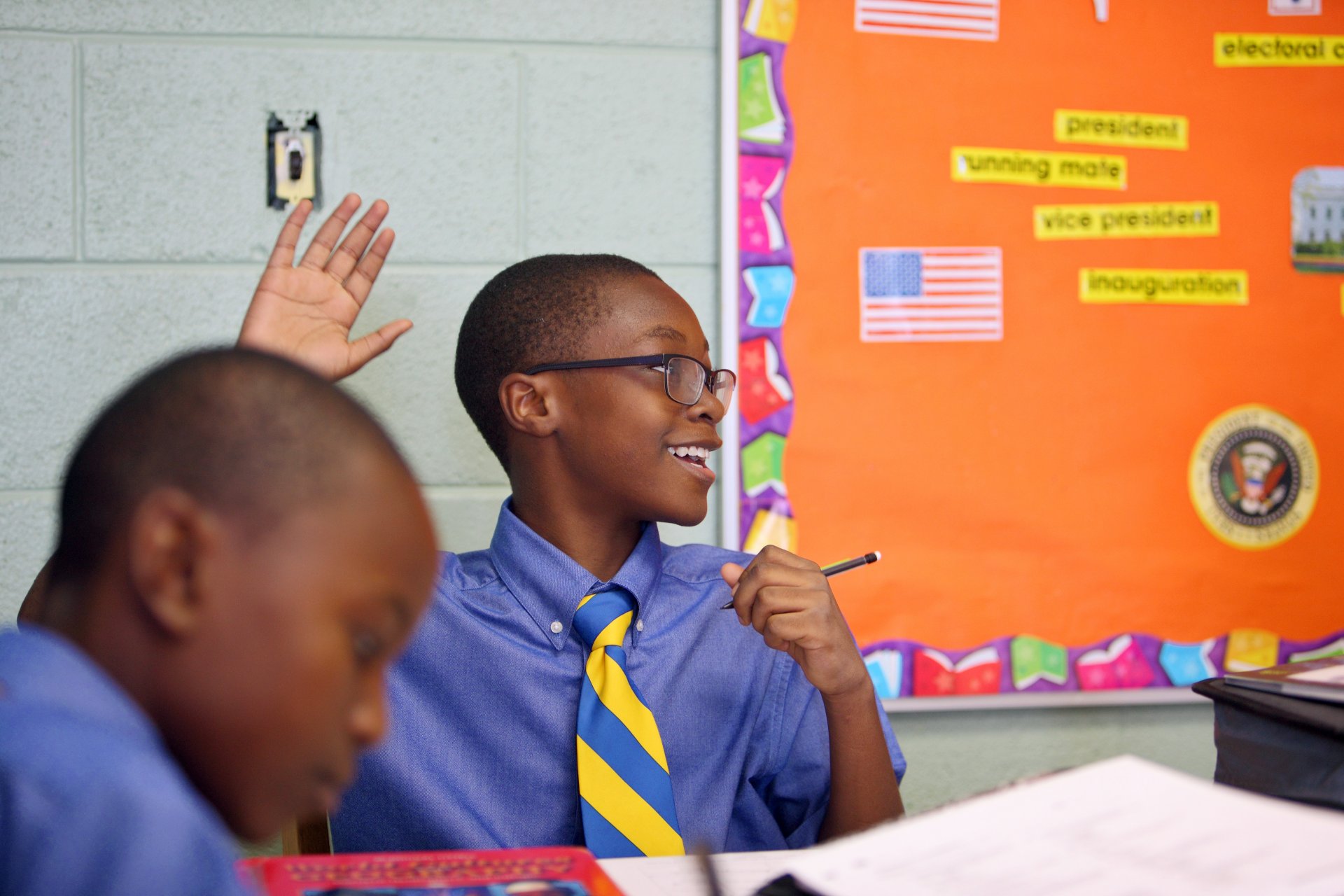 student and teacher playing rock, paper, scissors, shoot